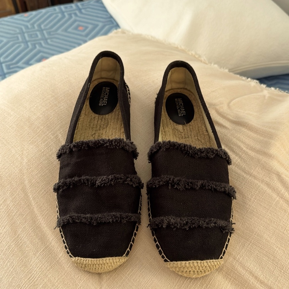 Michael Kors black espadrille flats. Black canvas with frayed fabric detail.